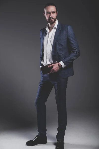 handsome fashion stylish hipster businessman model dressed in elegant blue suit