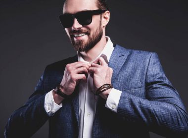 young businessman handsome model man dressed in elegant blue suit with accessories on hands  clipart