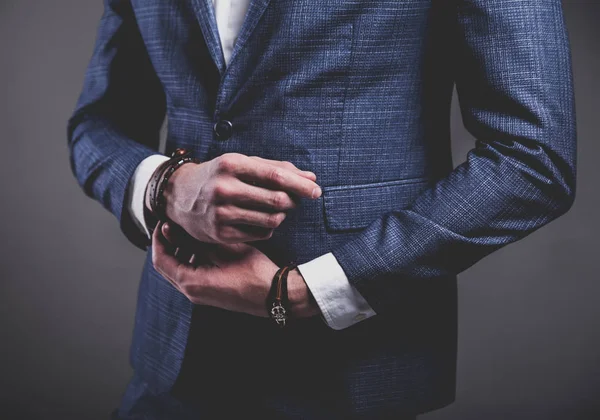 Young businessman handsome model man dressed in elegant blue suit with accessories on hands — Stock Photo, Image