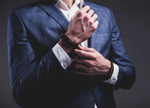 Joven hombre de negocios guapo modelo hombre vestido con elegante traje azul con accesorios en las manos —  Fotos de Stock