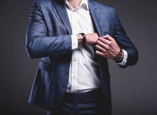 young businessman handsome model man dressed in elegant blue suit with accessories on hands 