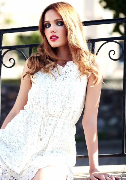 Glamour beauty portret van mooie sensuele Kaukasische jonge vrouw model met avond make-up in witte zomerjurk poseren op de straat achtergrond — Stockfoto
