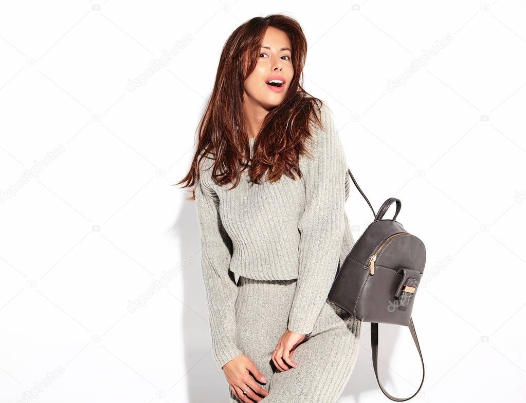 Portrait of beautiful cute brunette woman model in casual autumn gray sweater clothes with no makeup isolated on white with handbag