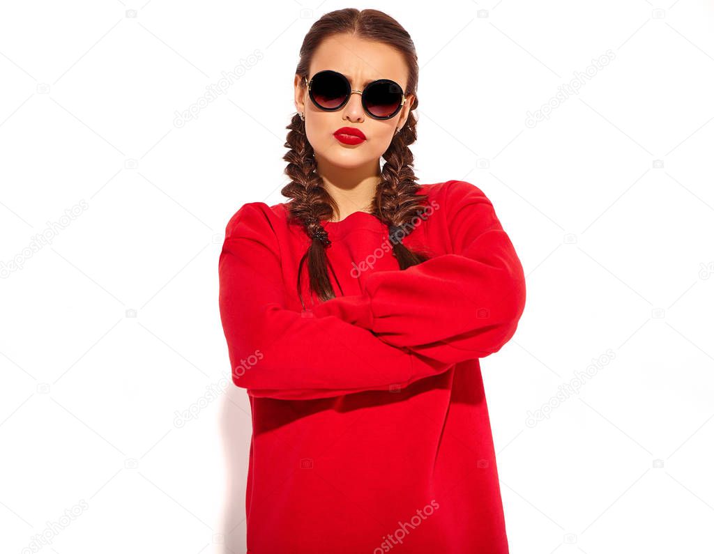 Portrait of young happy smiling woman model with bright makeup and colorful lips with two horns and sunglasses in summer red clothes isolated on white. crossed arms