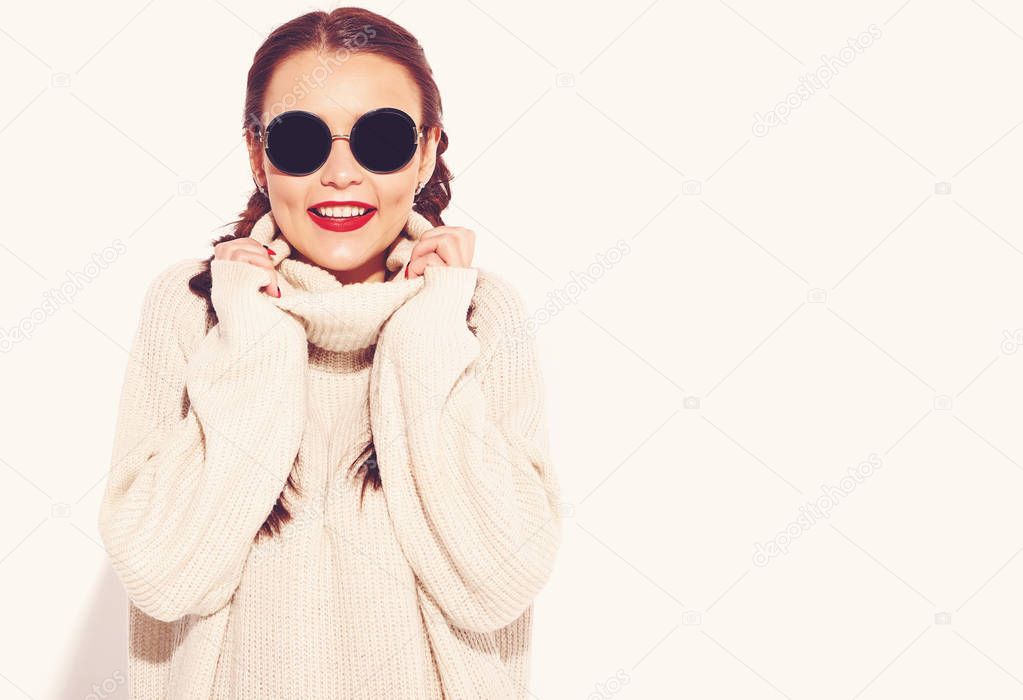 Portrait of young happy smiling woman model with bright makeup and red lips with two horns  in summer warm sweater clothes isolated on white. Going crazy