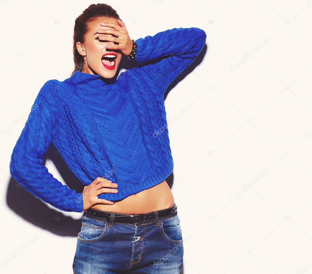 Portrait of young happy woman model with bright makeup and colorful lips in hipster summer blue sweater clothes isolated on white. Going crazy and hiding her face