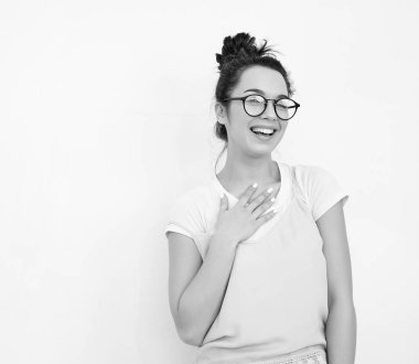 Genç güzel esmer kadın kız modeli renkli yaz pembe hipster giysileri duvara yakın poz çıplak makyaj ile portresi. Mutlu bir şekilde kamera arıyorum ve deli gidiyor 