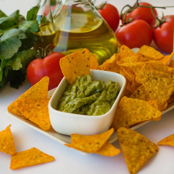 Homemade lemonade with salsa guacamole with corn chips and vegetables — Stock Photo, Image