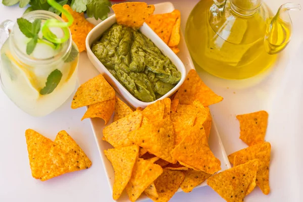 Homemade lemonade with salsa guacamole with corn chips and vegetables — Stock Photo, Image