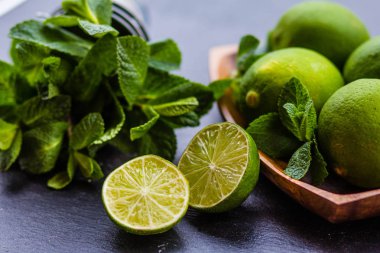 Malzemeler taze nane ve limon karanlık bir arka plan üzerinde