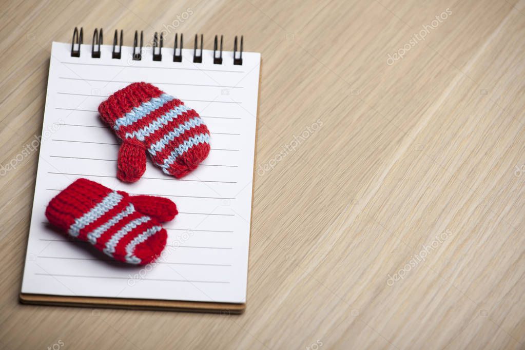 wool gloves notebook table background 