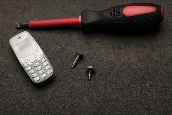 Mobile Phone Screwdriver Asphalt Background — Stock Photo, Image