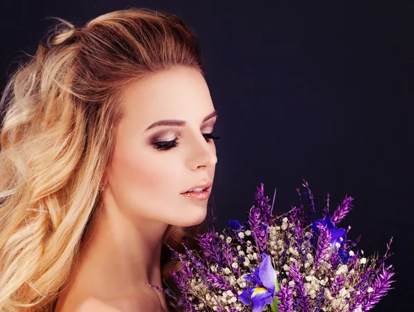 Blonde Beauty. Perfect Woman with Purple Flowers Stock Image