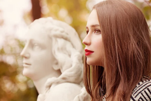 Autumn Portrait of Pretty Woman and Marble Statue Outdoors. Prof