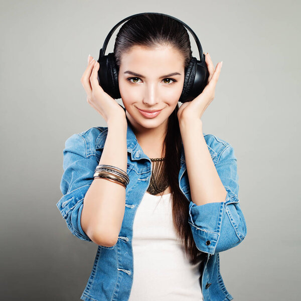 Young Cute Woman in Blue Denim Outfit Enjoying the Music 
