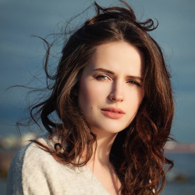 Dalgalı saç açık üfleme ile kız. Kadın güneş ışığı altında