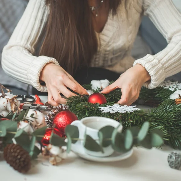 Christmas Garland with Female Hands, Cones, Evergreen Tree