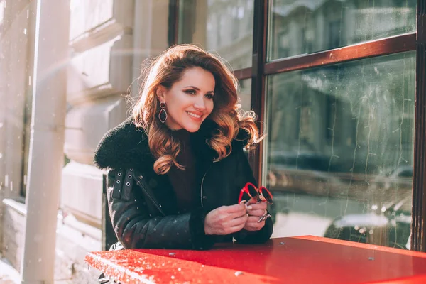 Smiling Redhead Woman Laughing in Street Cafe.