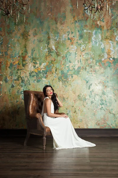 Beautiful woman fashion model wearing white dress relaxing — Stock Photo, Image