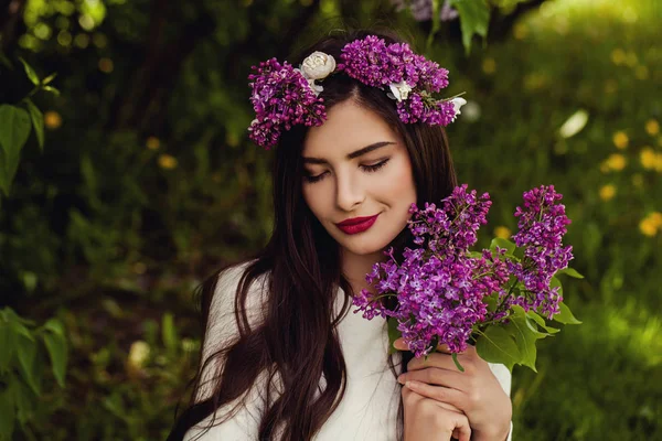 Cute young woman with summer flowers outdoors — Stock Photo, Image