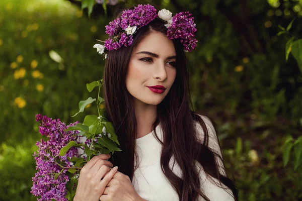 Romantic woman with flowers outdoors. Young beauty — Stock Photo, Image