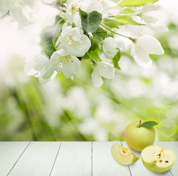 Green apple fruits on abstract background with green leaves