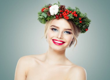 Happy woman with Christmas garland smiling on white
