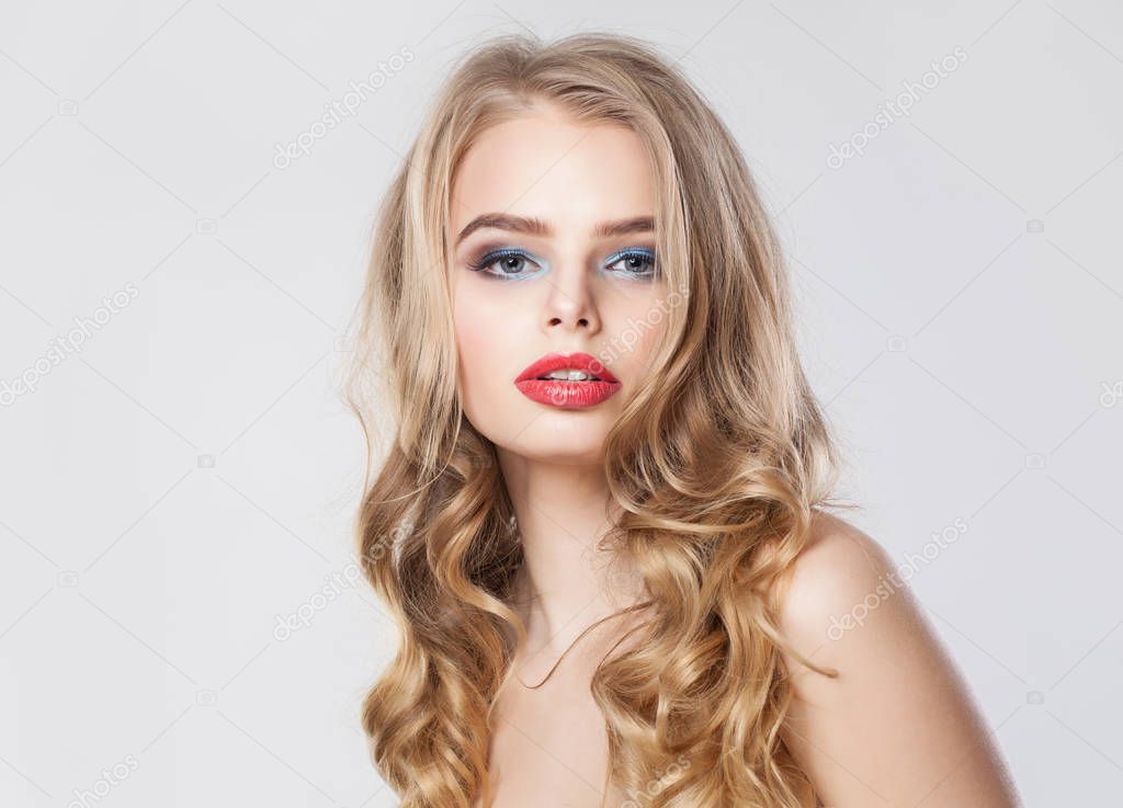 Cute blonde model woman with long healthy curly hair