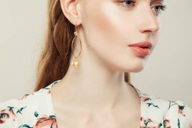 Beyaz inci küpeli güzel genç bir kadın. 