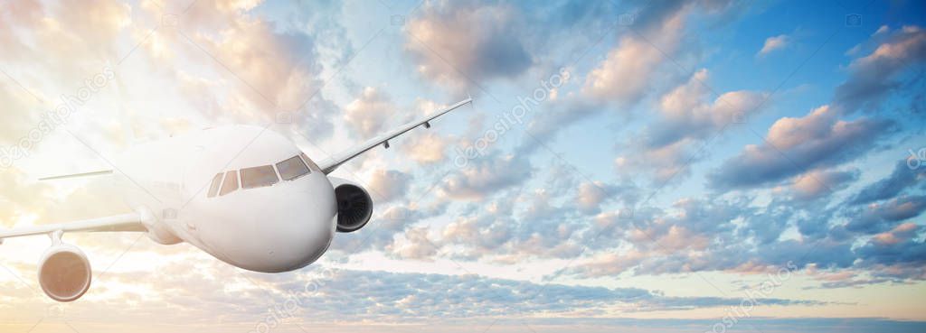 Plane against blue sky with clouds and sun. Travel, holidays 