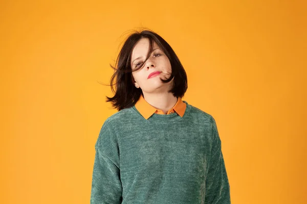 Confident young woman portrait on bright yellow background — 스톡 사진