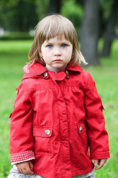 Serious or sad baby girl in red. Caucasian blonde real people gi Royalty Free Stock Photos