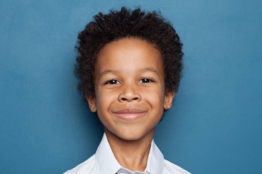Happy African American Child Boy Smiling on Blue Background.
