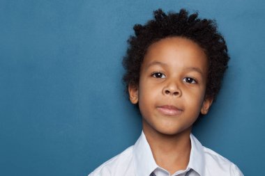 Curious African American child boy on blue background