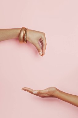 Taking and giving woman hands on pink background. 