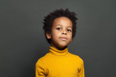Little child portrait. Small african american boy on gray 