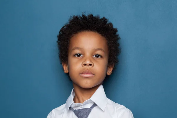 Retrato de curioso menino negro inteligente estudante no fundo azul. Afro-americano pupilo criança 6 anos — Fotografia de Stock