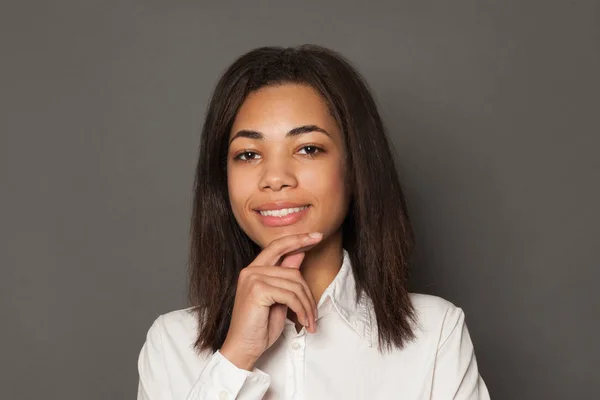 Inteligente jovem negro mulher estudante sorrindo no fundo cinza, rosto — Fotografia de Stock