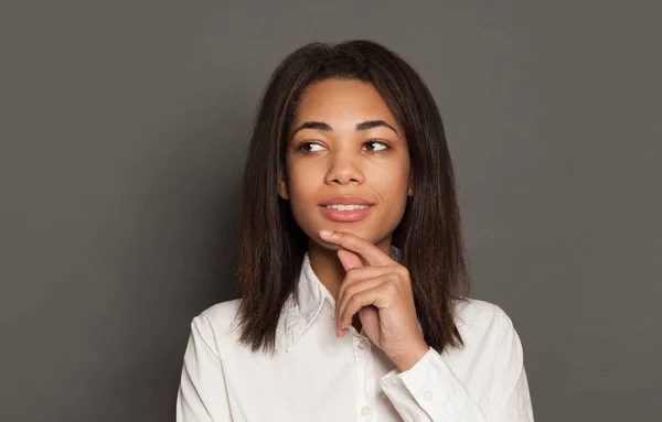 Gelukkig slim zwart vrouw brunette denken op grijs achtergrond — Stockfoto