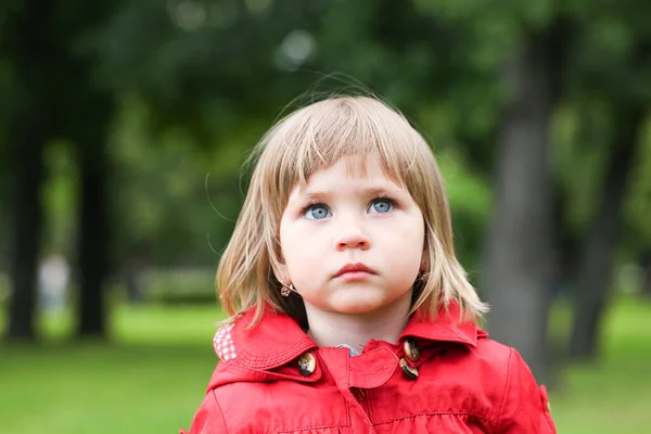 Serious or sad baby girl in red. Caucasian blonde real people gi — Stock Photo, Image