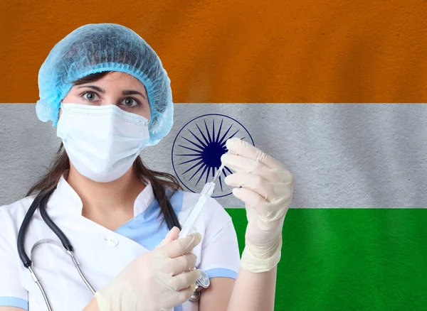 Scientist woman with test tube Coronavirus or COVID-19 against India flag. Research of viruses in laboratory for prevention of a pandemic in India