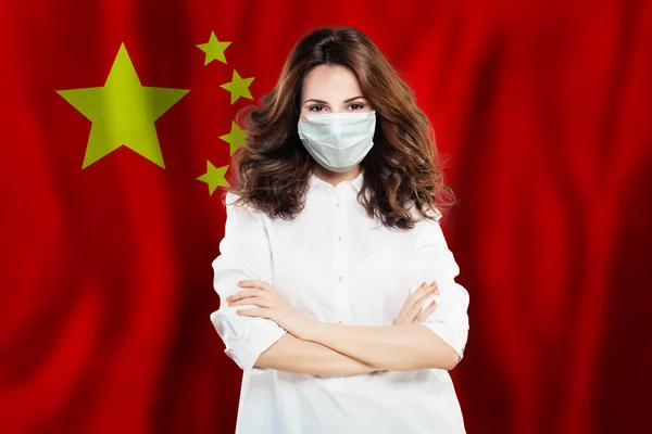 Doctor or nurse in medical safety face mask on Chinese flag background. Flu epidemic and virus protection in China concept
