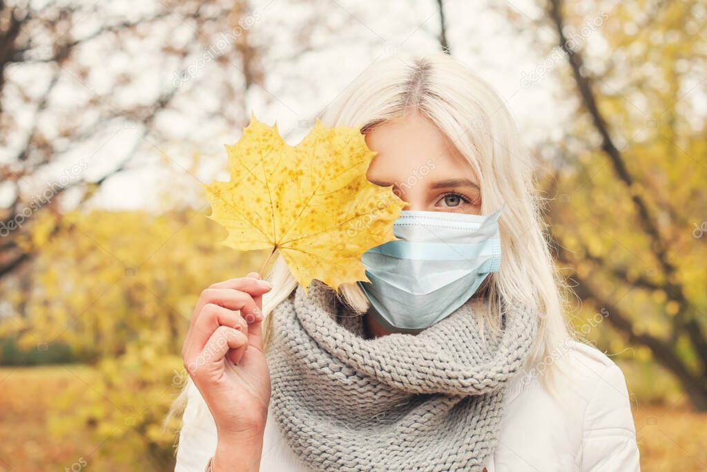 Woman in medical face mask walking outdoors