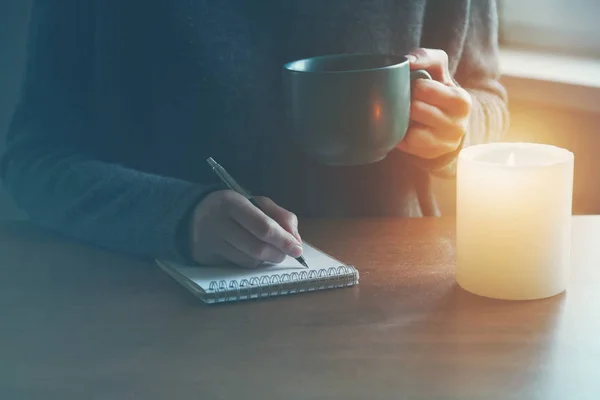 Female hands with pen and cup — Stock Photo, Image