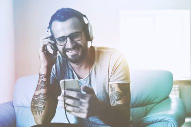 smiling man listening to music 
