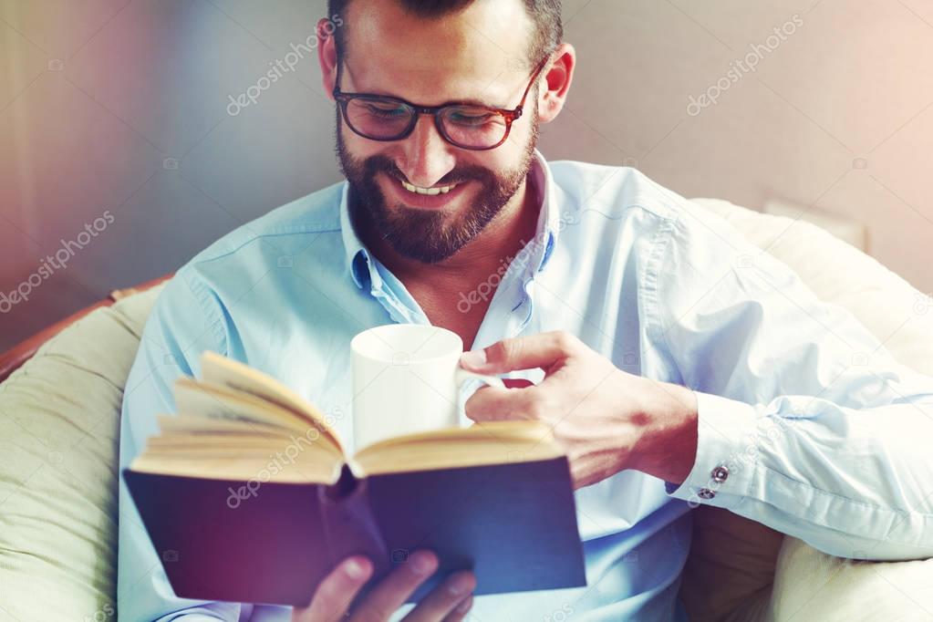 smiling man reading 
