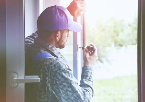 Service man installing window — Stock Photo, Image