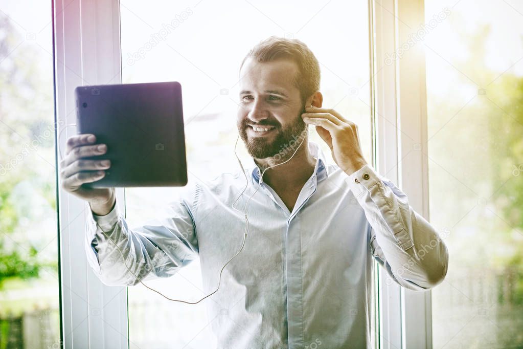 smiling businessman with digital tablet 