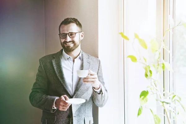 Handsome businessman holding morning cup — Stock Photo, Image