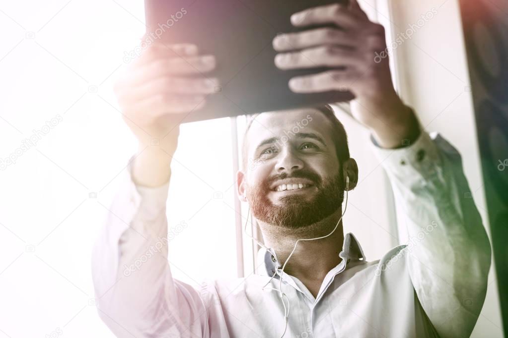 smiling businessman with digital tablet 